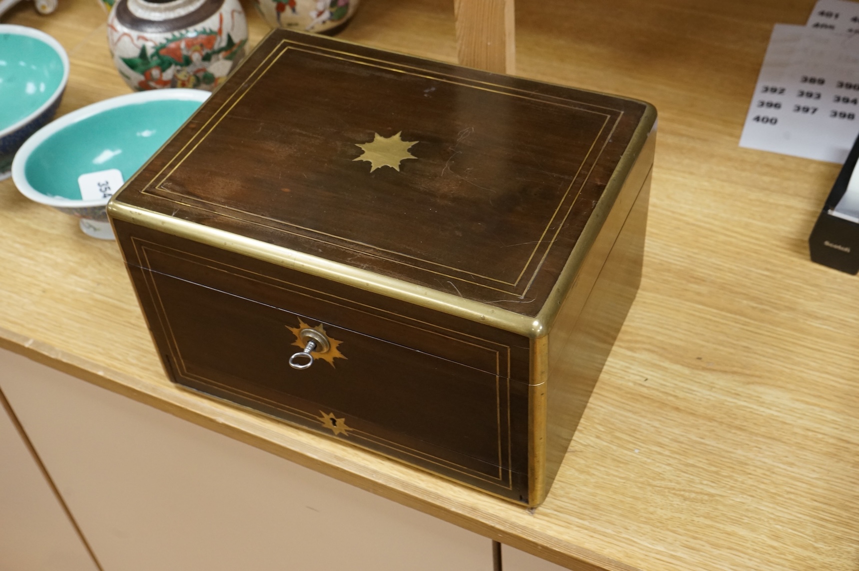 A mid 19th century mahogany brass bound and mounted toilet box, with tooled leather and velvet interior. Fitted inside with glass plated topped bottles and boxes. 31cm wide x 19cm high
